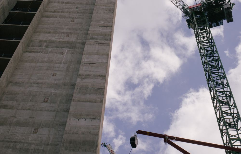 Tower cranes over a high-rise under construction