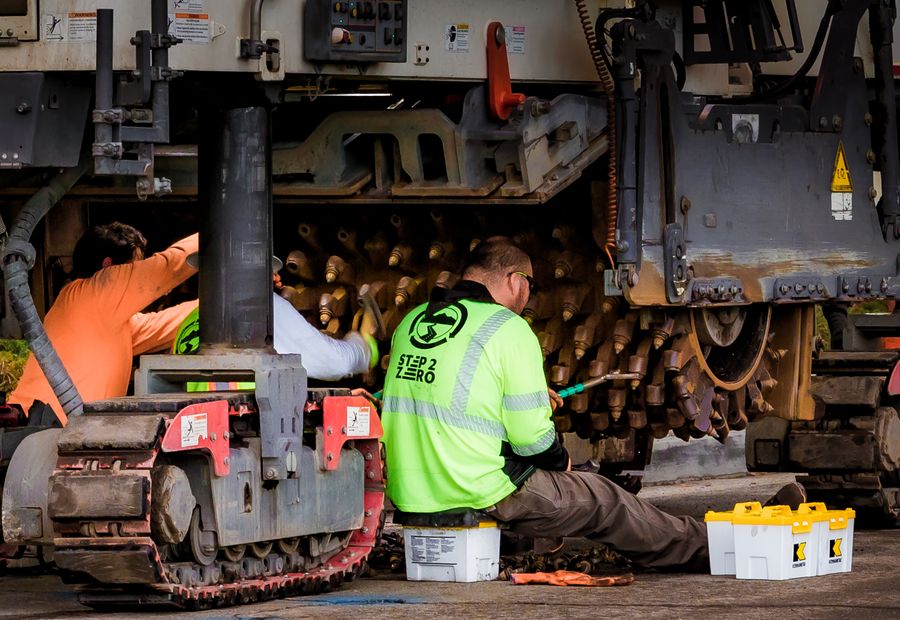Two technicians servicing plant in a workshop
