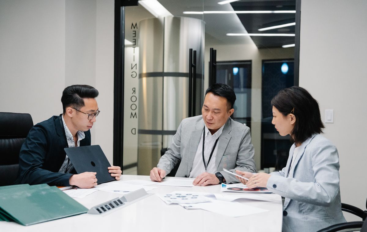 Finance team working through documents around a meeting-room table
